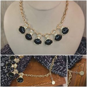 Black oval stone necklace on gold chain